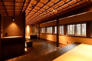 an empty room with windows and a wooden ceiling at Koyasan Shukubo Yochiin in Koyasan