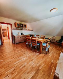a dining room with a wooden table and chairs at Apartmány Maříž in Maříž