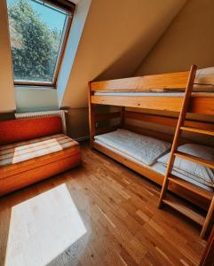 two bunk beds in a room with a window at Apartmány Maříž in Maříž