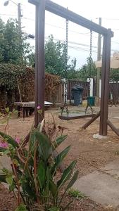 a park with a playground with a swing at Casa centro tabo in El Tabo