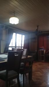 a dining room with a table and chairs and a window at Casa centro tabo in El Tabo +21 photos