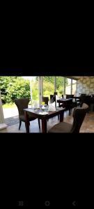 a dining room with tables and chairs and windows at Three-Bedroom House Perfect for Contractors and Small Groups, sleeps 5 people in Durham in Bishop Auckland