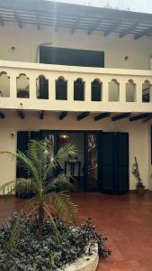 a building with a palm tree in a courtyard at Boutique 1970 Hotel in Asunción