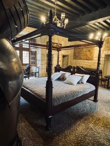 a bedroom with a canopy bed in a room at Château de Saint Maurice in La Peyrouse