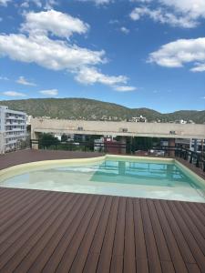 a swimming pool on the roof of a building at Amelia 2-4 in Villa Carlos Paz