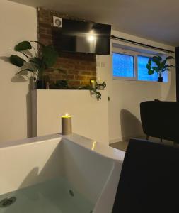 a white bath tub with a candle in a room at Suite 11 in Tourcoing