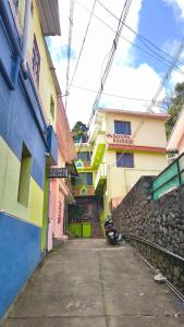 an alley between two buildings with a motorcycle parked in front at Padayappa Residency in Kodaikānāl +6 photos