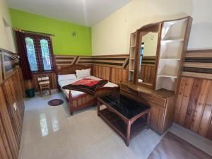 a bedroom with a dressing table and a mirror at Padayappa Residency in Kodaikānāl