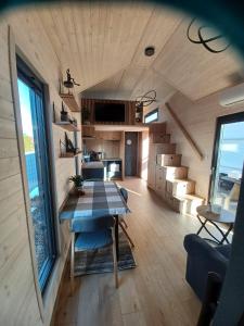 a kitchen and living room with a table in a tiny house at Tiny Schwarzwald in Schopfloch +11 photos