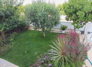 a garden with trees and flowers in a yard at Hikary in Lavra
