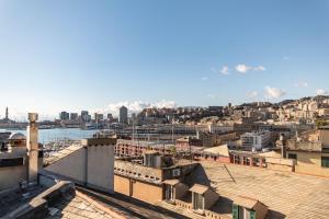 a view of a city with mountains in the background at Genova Suite Art in Genoa