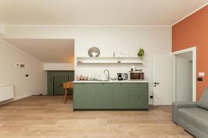 an open kitchen and living room with a couch at Genova Suite Art in Genoa