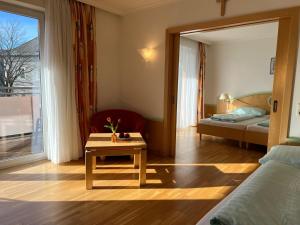 a room with a bed and a table in a room at Hotel zum Kirchenwirt Mariazell in Mariazell