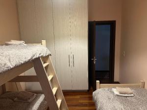 a bedroom with two bunk beds and a door to a room at Stymfalia Cozy Village Guesthouse in Kartérion