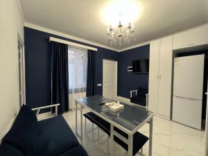 a living room with a table and a blue wall at Hotel in Yerevan in Yerevan