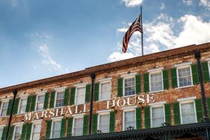 an american flag flying on top of a building at The Marshall House, Historic Inns of Savannah Collection in Savannah