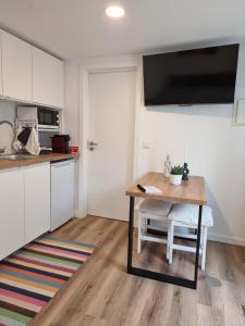 a kitchen with a wooden table and a small table with a chair at Hikary in Lavra