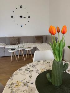 a living room with a table with a vase with flowers at Residency appartment in Danilovgrad