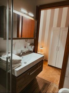 a bathroom with a white sink and a mirror at Foresteria Tosi in San Colombano al Lambro