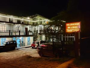 a car parked in front of a building at night at Coralberry Inn in Jāmb