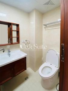 a bathroom with a toilet and a sink at Oak Suite in Baguio