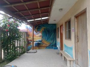 a mural on the side of a building with a bench at La tribu in Simiátug +2 photos