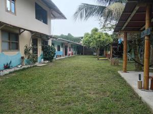 an alley between two buildings with a grass yard at La tribu in Simiátug