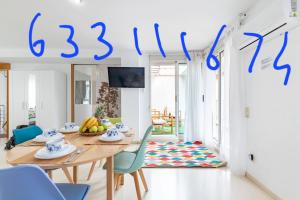 a living room with a table and chairs and a sign that reads at Grand Villa Valencia- large groups-8 min to Center by Metro in Valencia