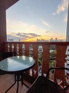 a balcony with a table and a view of the city at The Florentine Suite in Manila