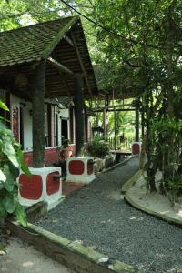 a house with a pavilion in front of it at Greenbay Beach Resort in Varkala