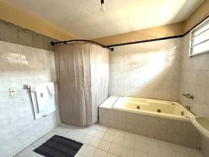 a bathroom with a tub and a shower and a sink at Colimota in Colima +13 photos
