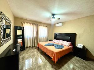 a bedroom with a bed and a ceiling fan at Colimota in Colima