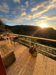 a view of the sun setting from a balcony at Tropical House in Ribeira Brava