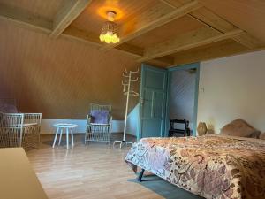 a bedroom with a bed and a table and chairs at Agroturystyka OLD ROAD 11 in Niedźwiedź