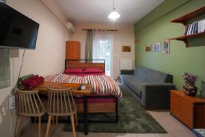 a room with a bed and a table and a couch at Marianna's studio in Kozani