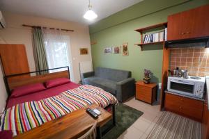 a bedroom with a bed and a couch in it at Marianna's studio in Kozani