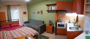 a small kitchen with a bed and a sink at Marianna's studio in Kozani