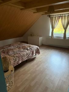 a bedroom with a bed and a large window at Agroturystyka OLD ROAD 11 in Niedźwiedź