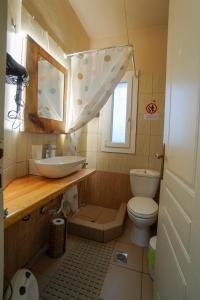 a bathroom with a sink and a toilet at Marianna's studio in Kozani