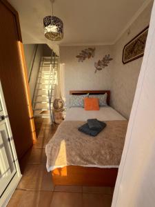 a bedroom with a bed and a staircase at Tropical House in Ribeira Brava