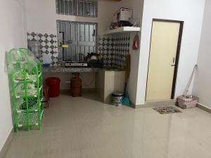 a kitchen with a counter and a door in a room at Jinkos Homestay with self cooking facility in Itānagar +3 photos