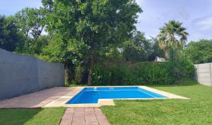 a small swimming pool in a yard next to a fence at CASA FUNES in Funes