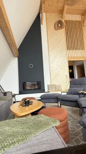a living room with couches and a table at La Salcami in Burzuc