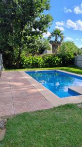 a small swimming pool in a yard next to a sidewalk at CASA FUNES in Funes