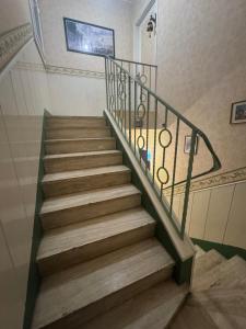 a staircase with a metal railing in a building at Appartement 3 pièces in Mareil-Marly