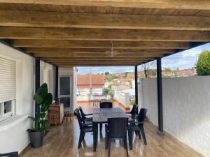 a dining room with a table and chairs on a patio at Casa As Estelas Camino de santiago por la costa Playa America in Nigrán