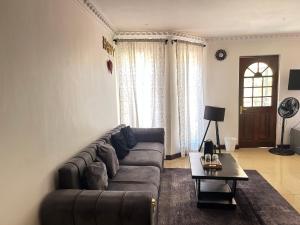 a living room with a couch and a table at Homely Palace in Midrand