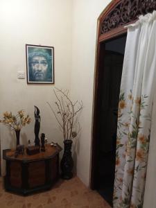 a room with a mirror and a table and a picture at peacock Rest in Batapola
