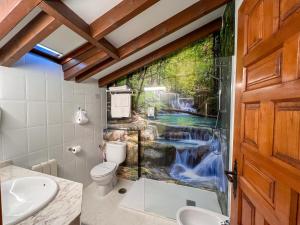 a bathroom with a waterfall mural on the wall at Posada Araceli in Santillana del Mar +113 photos