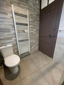 a bathroom with a toilet and a wooden door at Demeure d'autrefois in Passins +44 photos